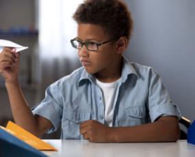Student with Paper Airplane